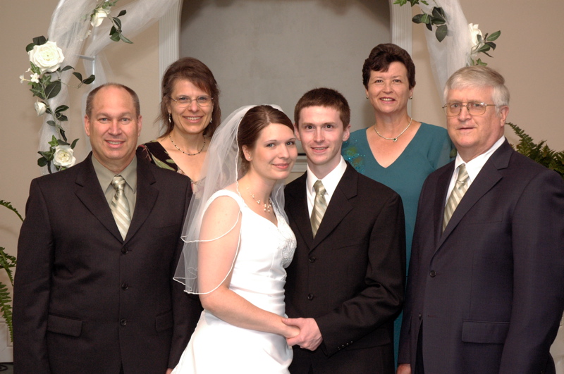 <p>Aaron and Kari at their wedding with their parents</p>