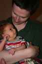 <p>Aaron holding Christian, while Christian looks at him</p>